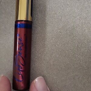 Moisturizing lip gloss, red delicious in color, new in pkg